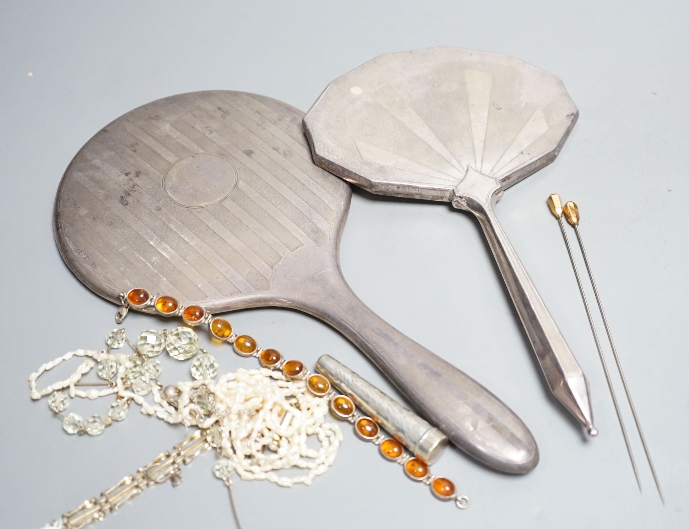 Two silver mounted hand mirrors and a small group of minor jewellery and a silver cigarette holder case.